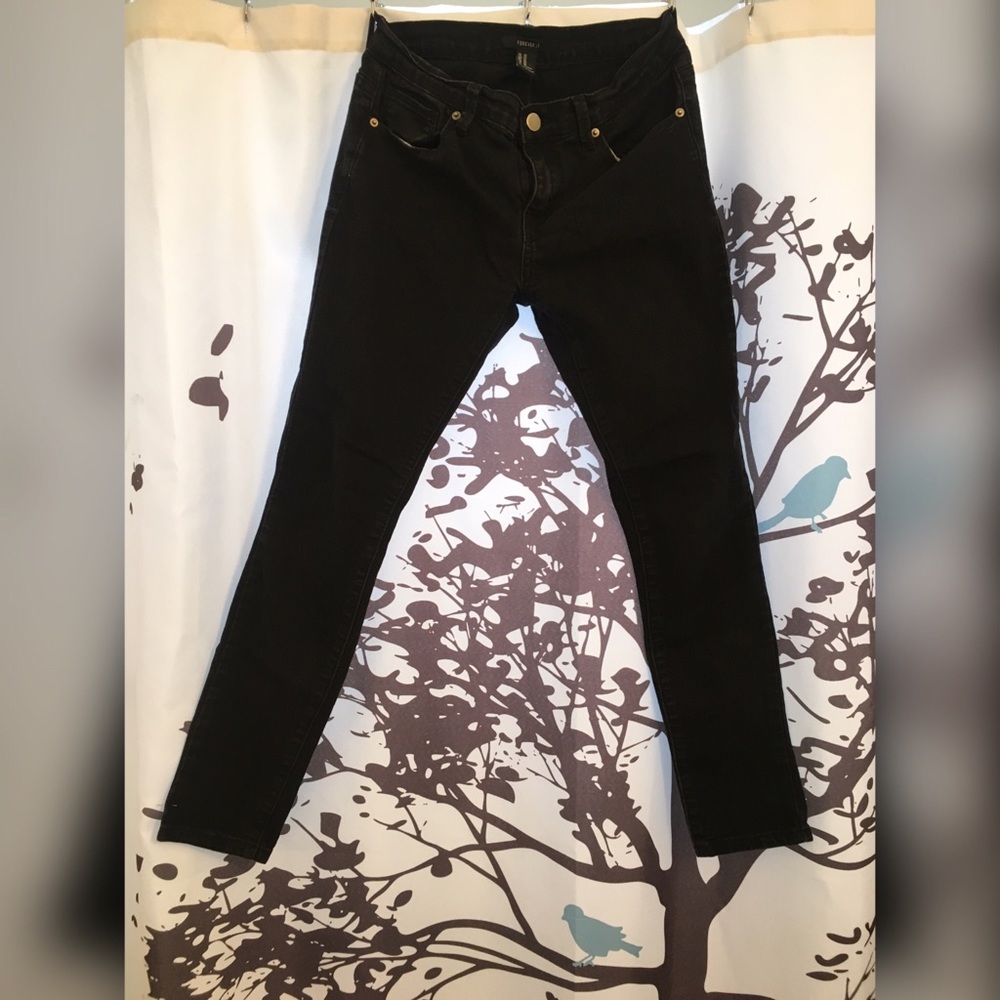 Worn stretchy black denim straight mid waist jean